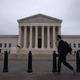 Morning commuters walk by The U.S. Supreme Court building May 24, 2021 in Washington, DC.